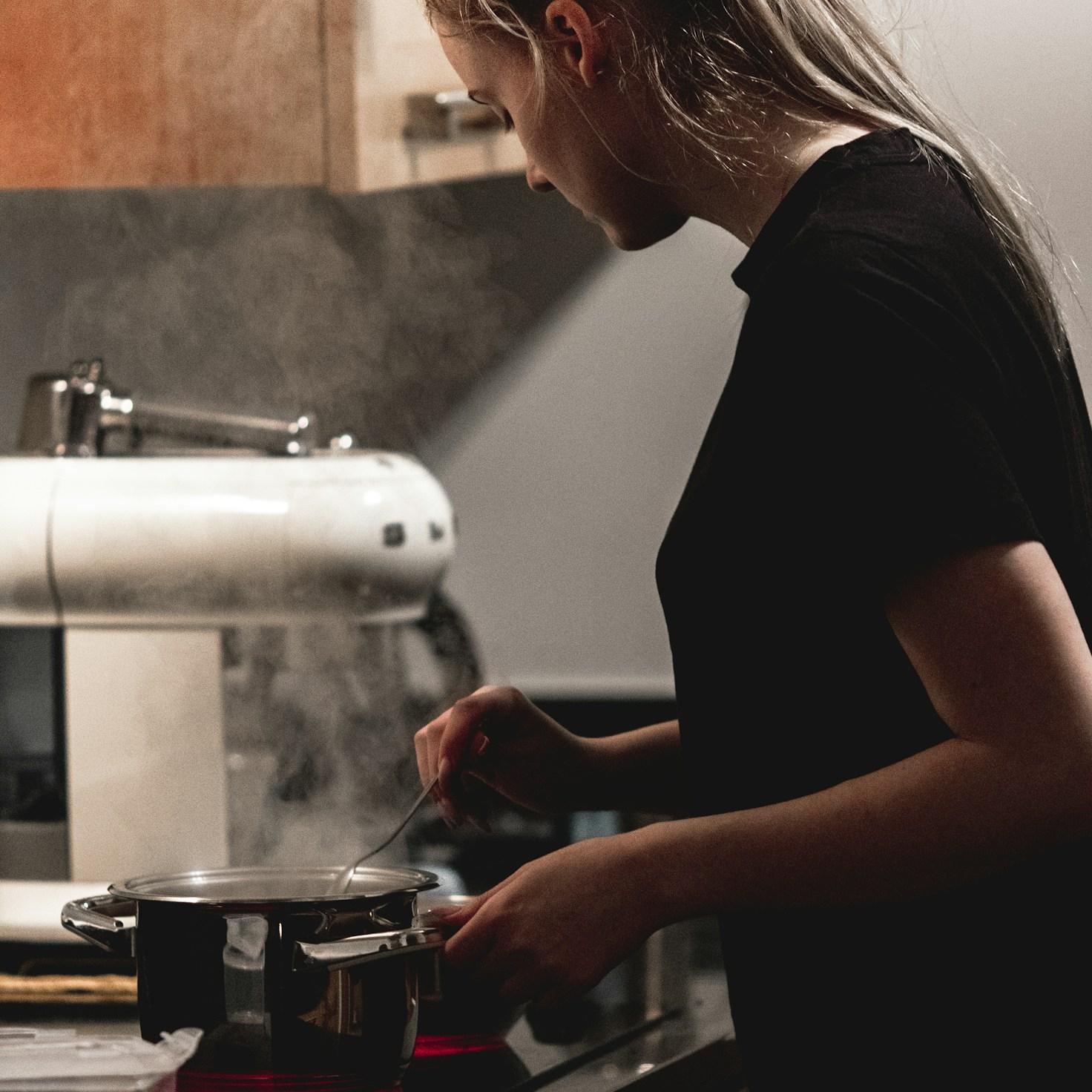 Community members collaborating in a modern kitchen space, sharing recipes and cooking techniques